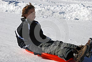 Scared Boy Sledding Down the Hill