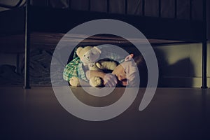 Scared Boy Sleeping Under his Bed with Teddy Bear