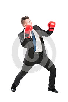 Scared business man wearing boxing gloves