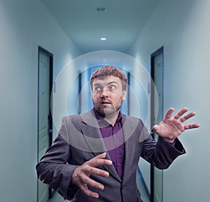 Scared businessman in the corridor