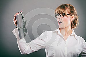 Scared businesswoman with chained document file.
