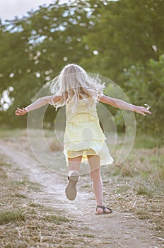 Scared child running in the nature in rural countryside