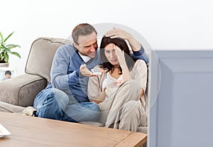 Scared couple watching a horror movie