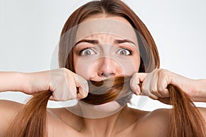 Scared frightened young woman covered mouth with her long hair