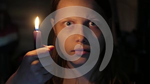 Scared girl with a candle