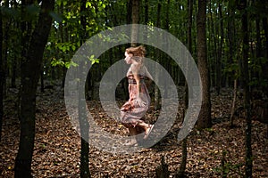 Scared girl running through forest