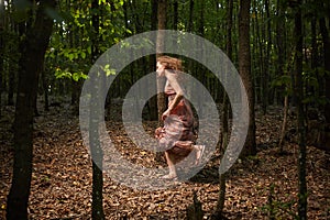 Scared girl running through forest