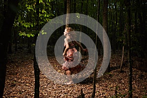 Scared girl running through forest