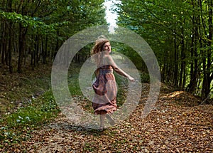 Scared girl running through forest