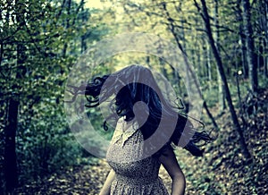 Scared girl running in the forest photo