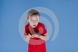 Scared little girl looking away dressed in red T-shirt,