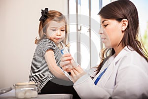 Scared little girl looking at a syringe