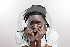 Scared man face with dreadlocks on white background