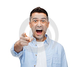 Scared man shouting and pointing finger on you