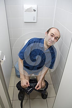 Scared man in toilet