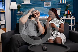 Scared man and woman watching horror movie