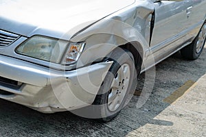 A scared marks on a front-left car body from accidentally hit by fast drive motorcycle, show broken mirror of flashlight cover