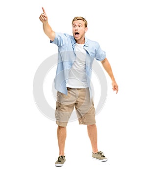 Scared, pointing finger and a man shouting in studio to for attention to show announcement space. Young male model with