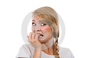 Scared, stressed woman biting her nails