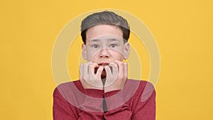 Scared Teen Boy Shaking From Fear Posing Over Yellow Background