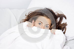 Scared woman in bed