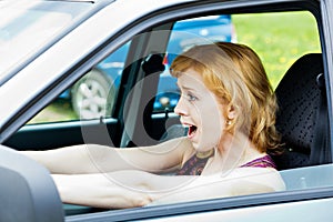 A scared woman behind the wheel