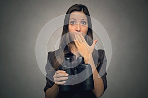 Scared woman with binoculars.