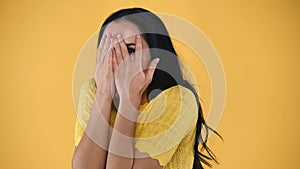 scared woman covering face with hands