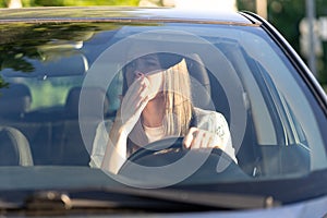 Scared woman driver look in rear view mirror frightened of car accident. Stressed girl in vehicle