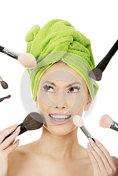 Scared woman has brushes around face.