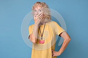 Scared woman looks at camera covering mouth with hands feel horrified photo