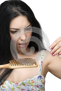 Scared woman lose hair on hairbrush