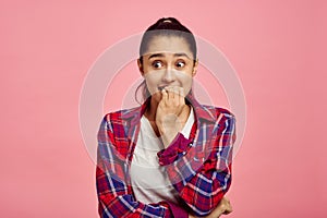 Scared woman portrait, pink background, emotion