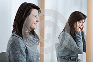 Scared woman simulating good mood