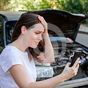 Scared woman in stress holding her head after auto crash calling to auto insurance for help. Driver woman portrait in
