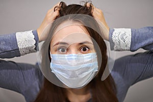 Scared woman wearing medical mask, close up