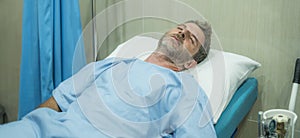 scared and worried man hospitalized - attractive injured man lying on hospital bed receiving treatment sick and unwell