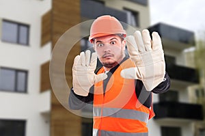 Scared young architect doing stop gesture