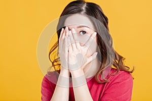 Scared young asian woman with hand cover face