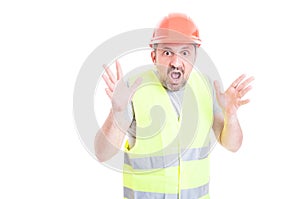 Scared young builder screaming and looking terrified