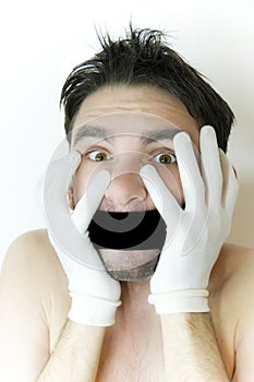 Scared young man with a bandage on a mouth