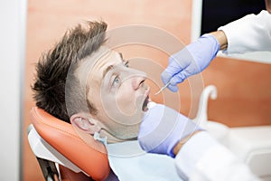 Scared young man at dentist office