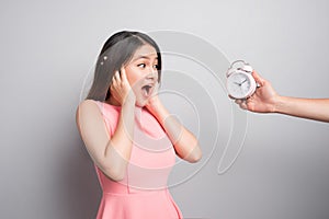 Scared young woman looking at camera over white background