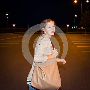 Scared young woman running from her pursuer