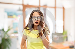 Scared young woman or teenage girl in glasses