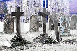 Scarey grave yard with ano old church behind black and white photograph