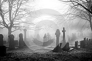 Scarey grave yard in the mist back and white photograph photo