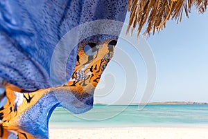 Scarf flying in wind on a sandy beach