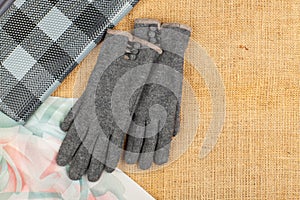 Scarf, handbag and gloves isolated on linen background.