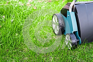 Scarifier on green grass. Work in the garden.